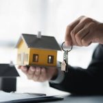 Un agent immobilier en train de donner des clés de maison